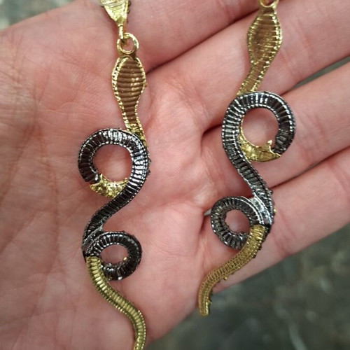 Snake earrings new with black and gold stones