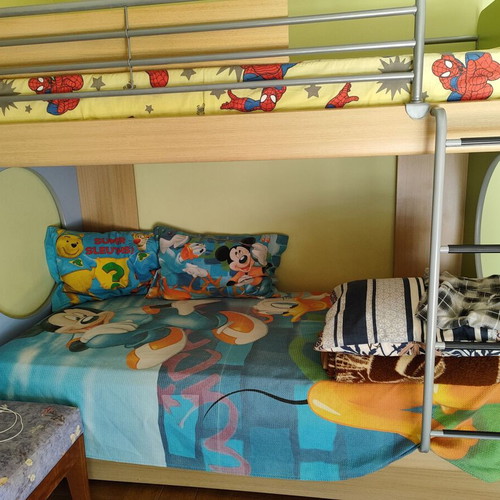 Bunk bed with three mattresses used, includes desk and drawers