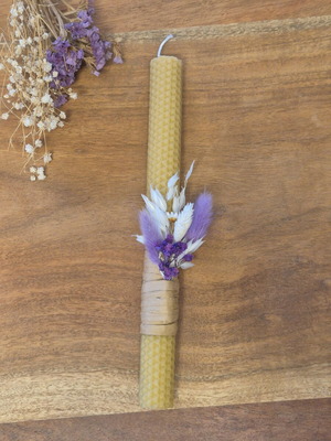 Handmade beeswax candle with dried flowers