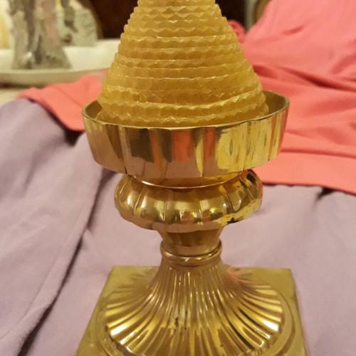 Solid brass candlestick with beeswax candle used