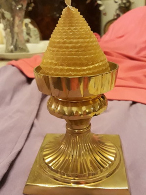 Solid brass candlestick with beeswax candle used
