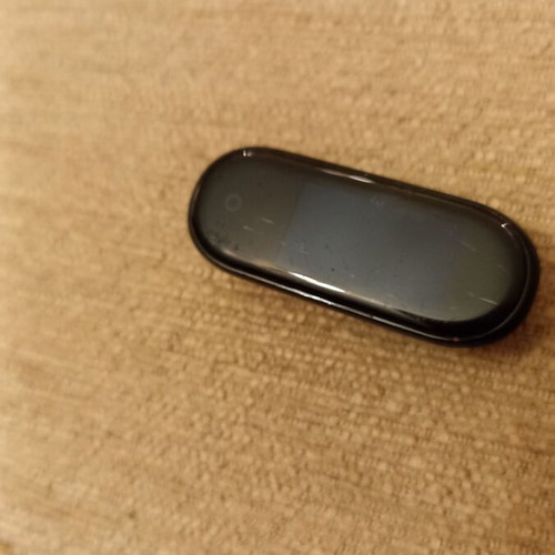 Mi Band smart watch used with charger, strap needs replacement