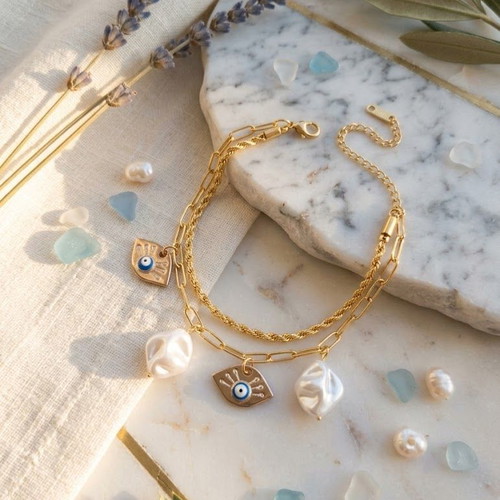 Double steel bracelet with decorative charms and faux pearls