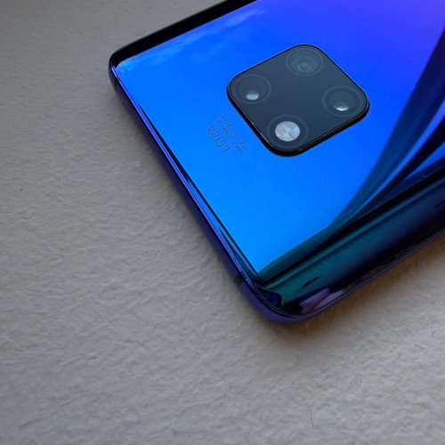 Huawei Mate 20 Pro smartphone with charging cable, cracked screen