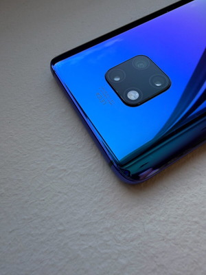 Huawei Mate 20 Pro smartphone with charging cable, cracked screen