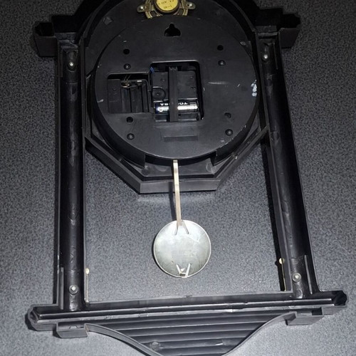 Quartz wall clock with pendulum used, faux wood plastic
