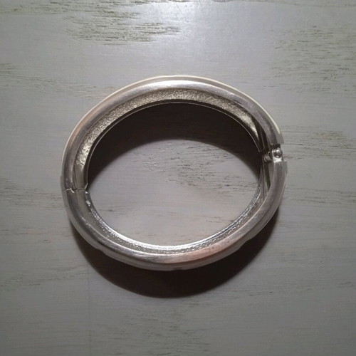 Women's silver handcuff bracelet like new with white pattern