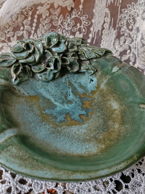 Majolica ashtray like new with raised floral decoration in green