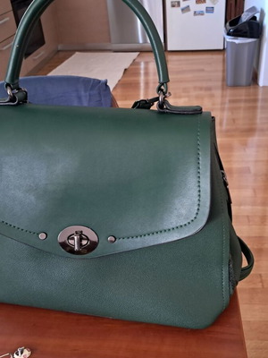 Green faux leather shoulder bag with burgundy interior