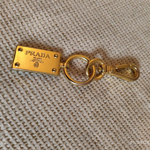 Authentic Prada gold key ring unisex like new