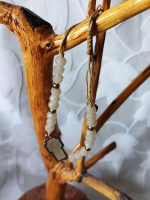 Bracelet with white beads and cross, like new, gold and beige details