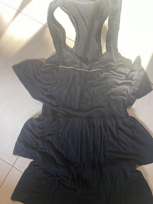 Black sleeveless blouse with ruffles and sporty back like new, size M