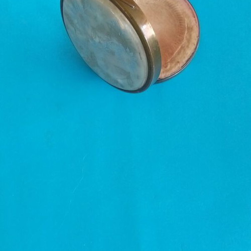 Antique powder compact used with metal bronze casing