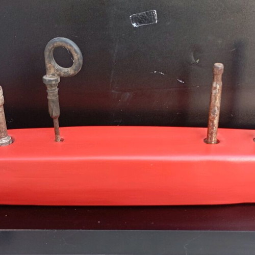 Sculpture ship used made of red clay and recycled metals on wooden base
