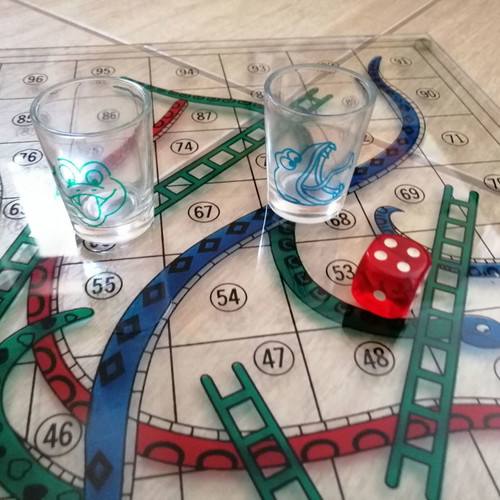 Glass Snakes & Ladders board game used with shot glasses