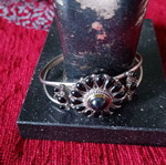 Ethnic cuff bracelet used with black cabochons in rosette shape, silver alloy