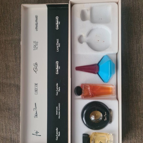 Collection of vintage fragrance miniatures in a case
