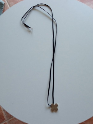 Silver cross with cord like new
