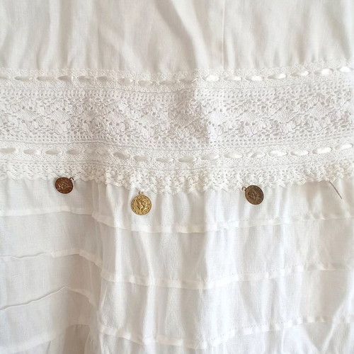 Long white dress used with lace and fake coins