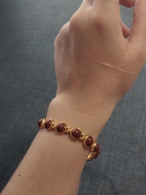 Vintage women's bracelet with red/brown cabochon beads on gold base, like new