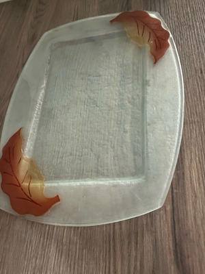 Decorative glass tray used with embossed leaf design