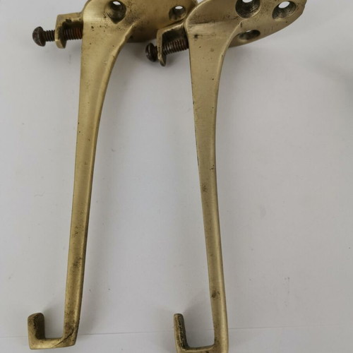 Pair of brass curtain hooks with clamp used