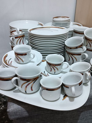 Porcelain set like new, 17 fruit plates, 12 dinner plates, 12 soup plates, 6 tea cups, 6 Greek coffee cups, 6 Nescafe cups, oval platter