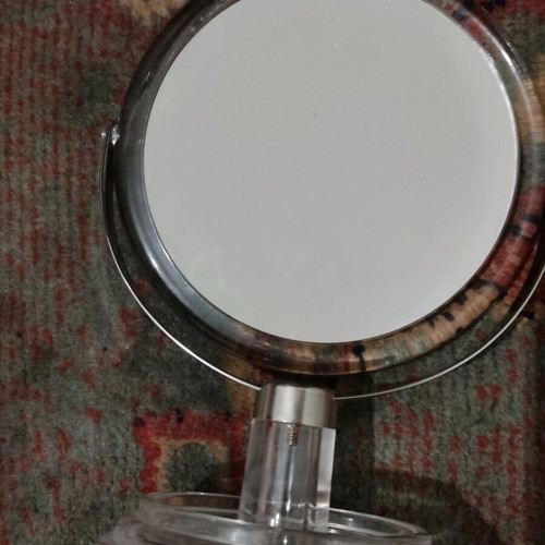 Small mirror used with magnifying side