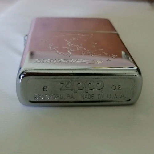 Zippo lighter used with engraved Greek map design