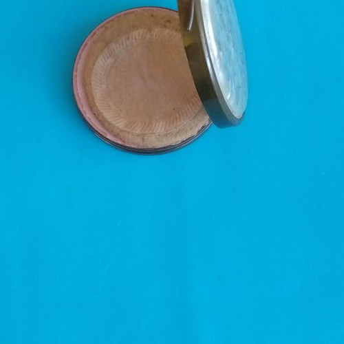 Antique powder compact used with metal bronze casing