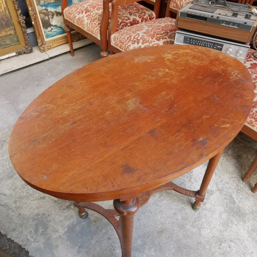 Vintage oval wooden coffee table used with brass feet