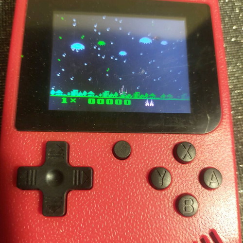 Retro style handheld game console used, working