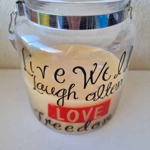 Aromatic candle in glass jar with quote