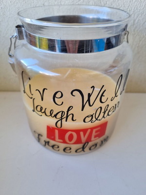 Aromatic candle in glass jar with quote