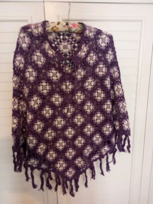 Handmade knitted poncho used in purple shades with fringes