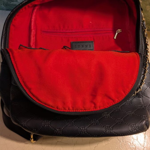 Women's black backpack with gold details like new