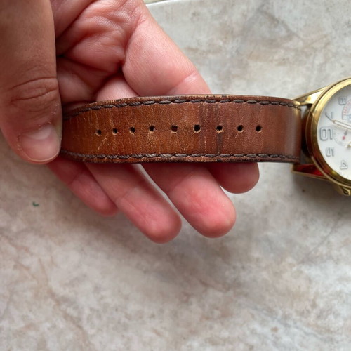 Tommy Hilfiger watch used with brown leather strap and gold dial