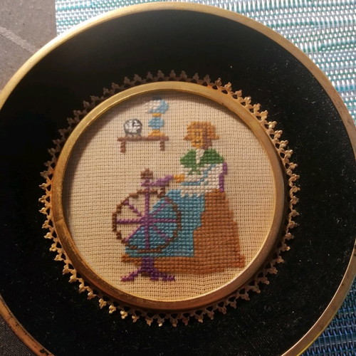 Handmade framed embroidery used with cross-stitch and glass