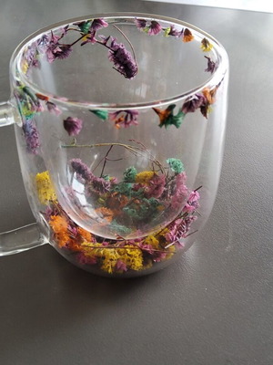 Glass mug new with internal decoration of dried flowers