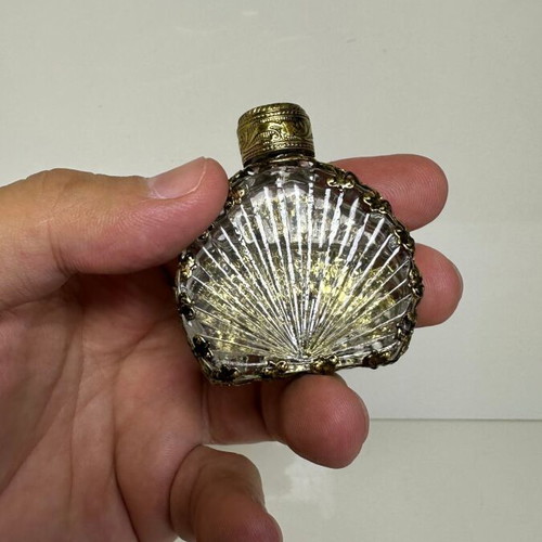 Vintage perfume flacon with filigree metalwork and red cabochon