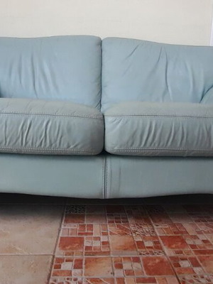 Leather two-seater sofa used with wear