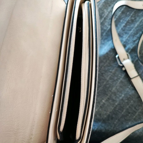Beige crossbody bag used with adjustable strap