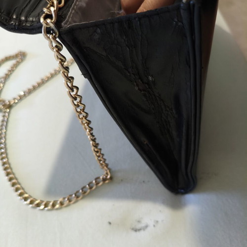 Black clutch bag with gold chain used, synthetic leather