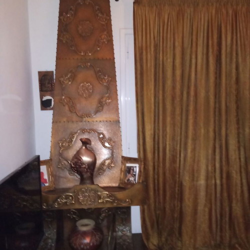 Decorative fireplace set with table and copper wall plaque