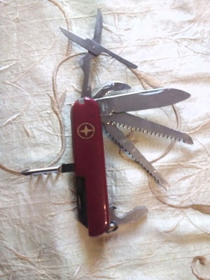 Multitool pocket knife like new with saws, screwdriver, scissors, and more