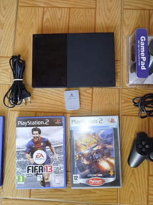 PlayStation 2 slim console used with 3 games and 2 controllers