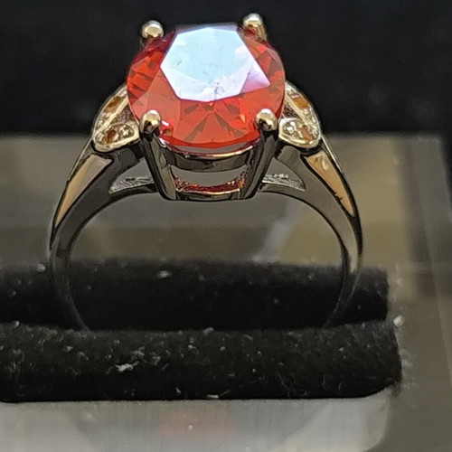 Ring with Large Red Ruby-Colored Stone and Decorative Stones