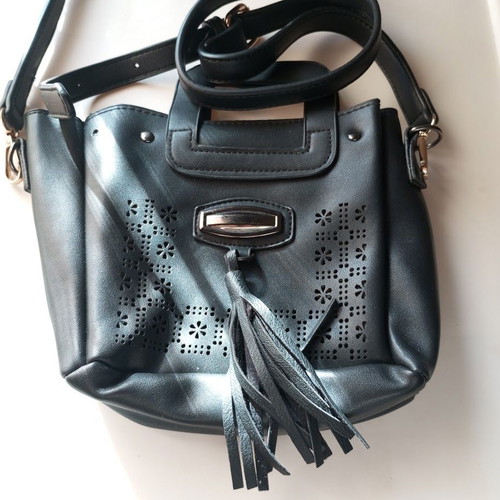 Black Women's Shoulder Bag like new with laser-cut patterns and tassels