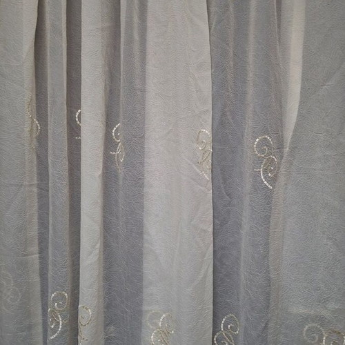 Set of two ready-sewn curtains in sugar color with embroidered designs