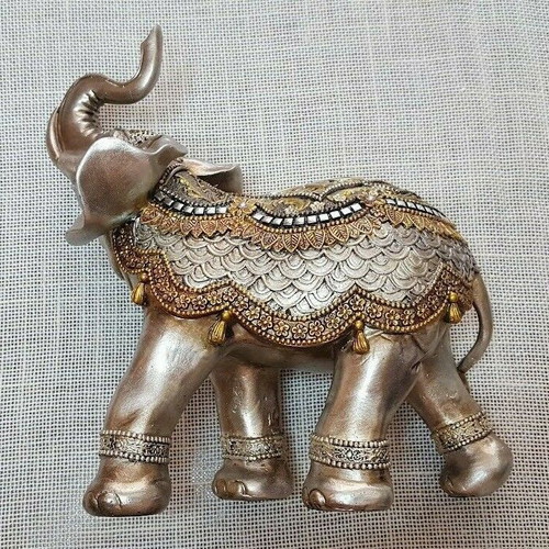 Handmade wooden elephant used with decorations and crystals